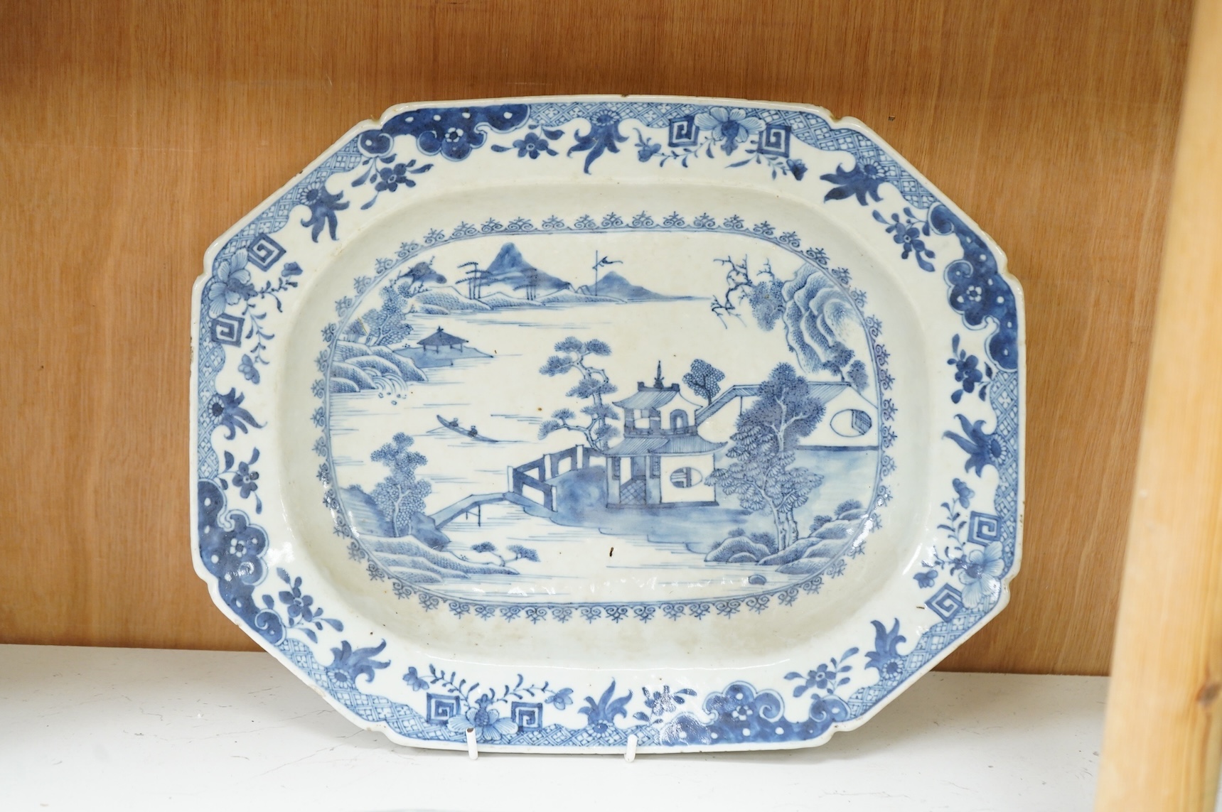 A late 18th century Chinese export blue and white serving dish and a similar famille rose serving platter, largest 37.5cm